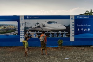 Poster for a Chinese high-speed train at the construction site for a bridge over the Mekong River near Luang Prabang, Laos. Photo: Adam Dean for The New York Times