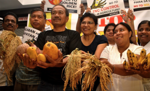 Asian farmers and leaders displaying the various natural sources of Vitamin A.