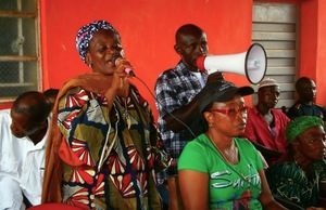 Safiya Vandi (in green t-shirt), pictured at a meeting of communities affected by the SOCFIN plantations in Pujehun, Sierra Leone. When bulldozers came to clear her land, Vandi stood in front of them. (Photo: Green Scenery)