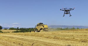 Aerial drone and combine harvester in a version of the new pastoral in a French wheat field. Photo: incamerastock/Alamy