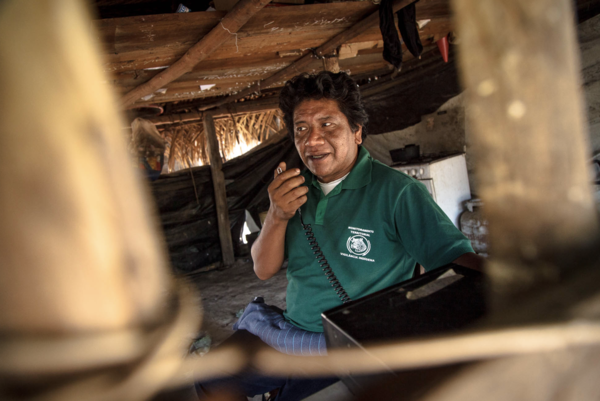 The indigenous leadership Dototakakyre Kayapó (known as Dotô) on a HAM radio, which Kayapó communities employed to collectively map out the operations of Jotinha's network int their land. © Marcio Isensee e Sá